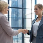 889b8669-c61e-43ee-ae53-e6970bb16e0b-image-two-business-women-shaking-hands-after-set-deal_484651-18834.jpg